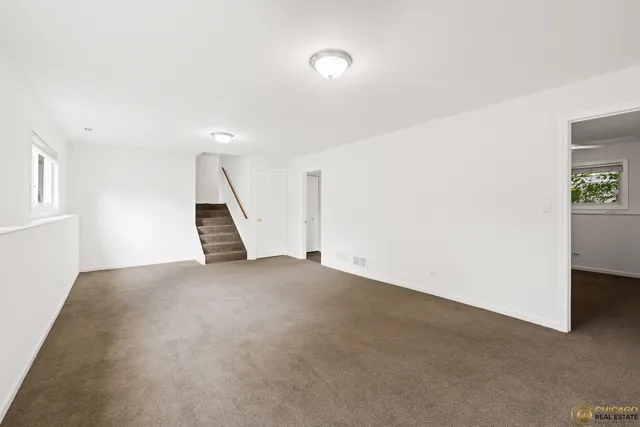 a view of an empty room with stairs