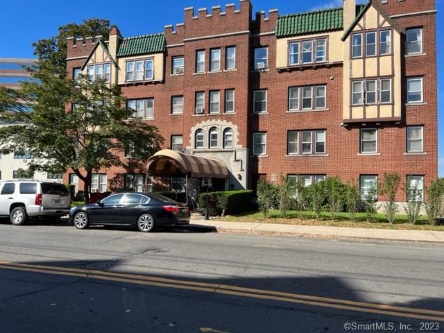 22 Glenbrook Road, Unit 209 Stamford, CT 06902 - Photo 1 of 1 a view of a brick building next to a road