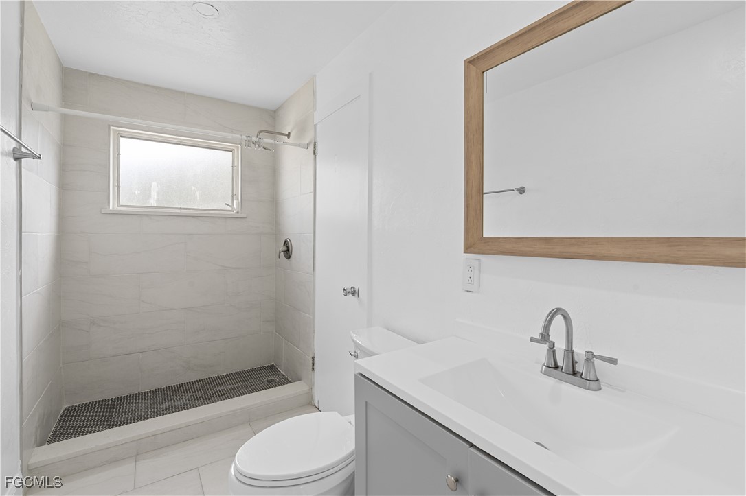 1450 Charles Road Fort Myers, FL 33919 - Photo 14 of 23 a bathroom with a sink toilet and shower