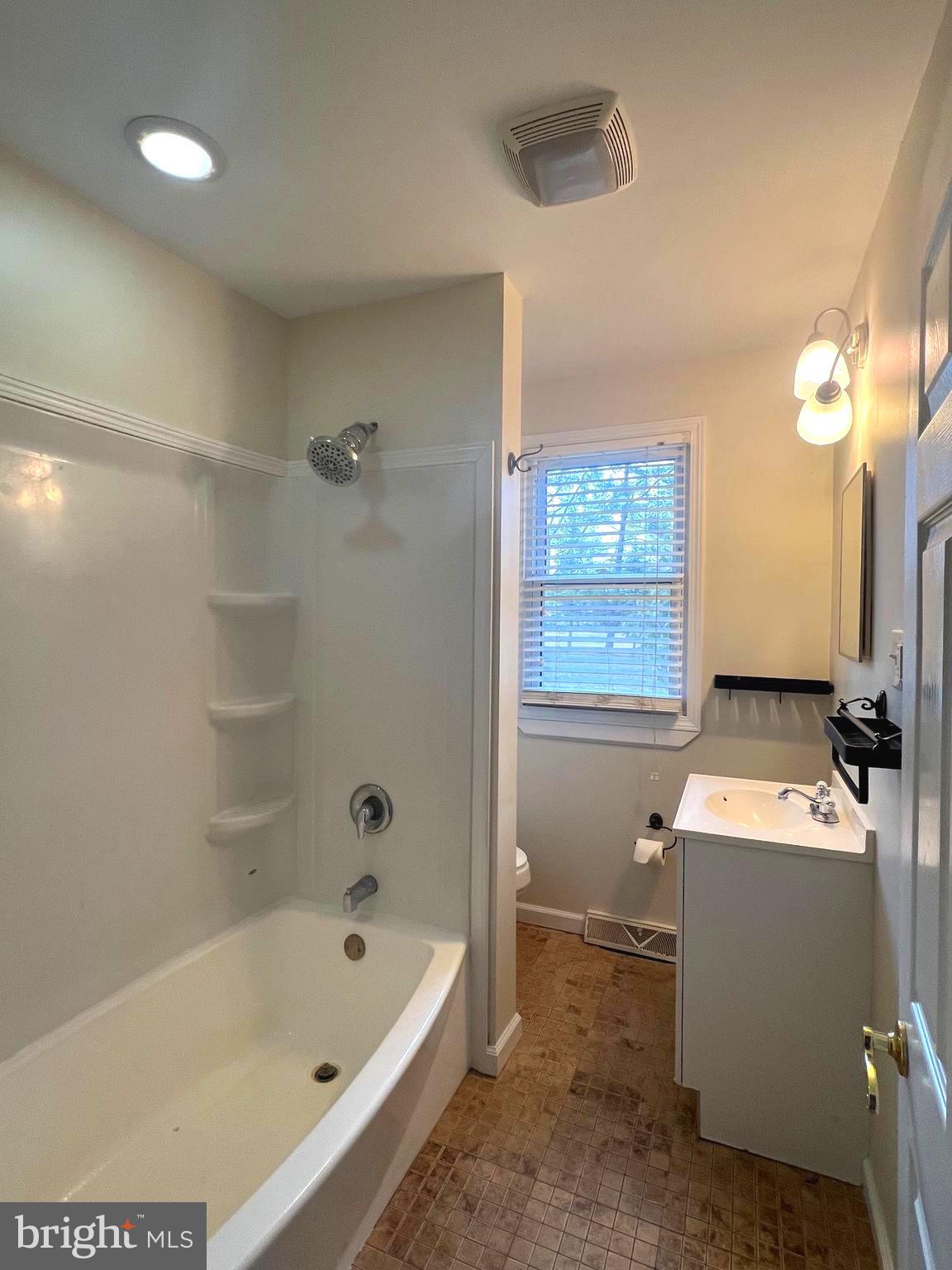 301 Pemberton Road Southampton, NJ 08088 - Photo 12 of 29 a bathroom with a sink a bathtub and a window