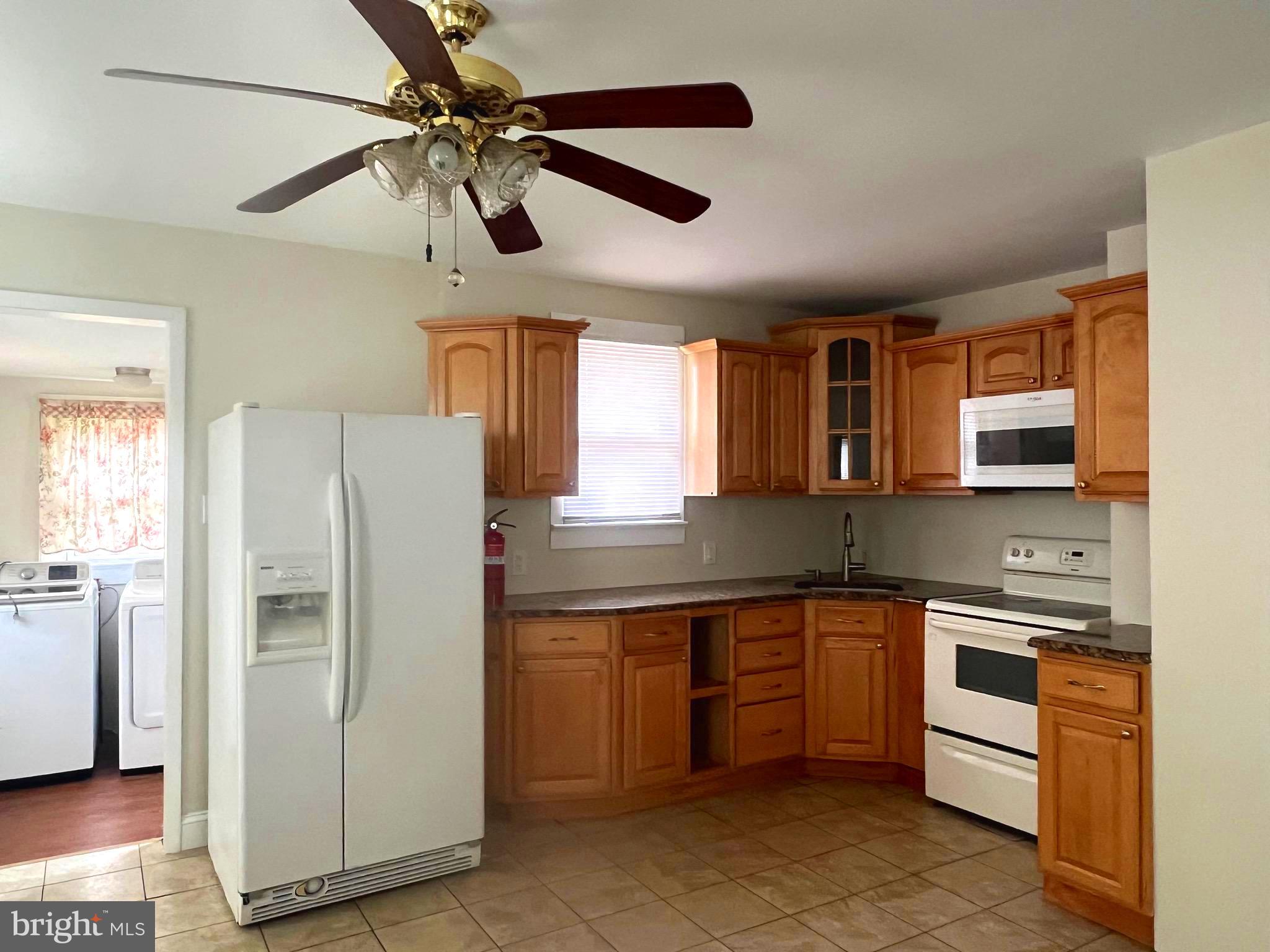 301 Pemberton Road Southampton, NJ 08088 - Photo 8 of 29 a kitchen with stainless steel appliances granite countertop a refrigerator a sink dishwasher a stove with wooden cabinets