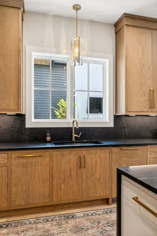 a kitchen with granite countertop a stove and a refrigerator