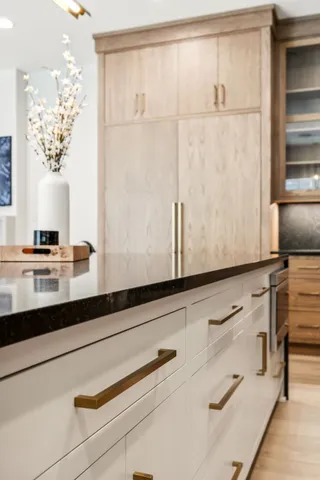 a kitchen with stainless steel appliances a sink and a table