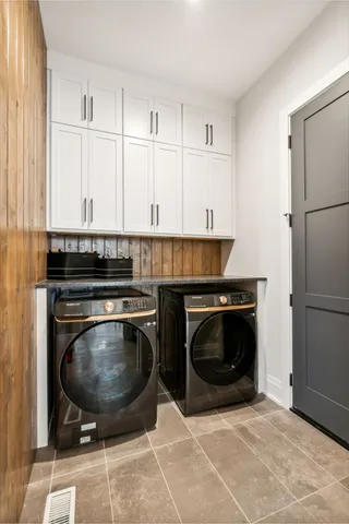 a bathroom with a tub shower sink and mirror