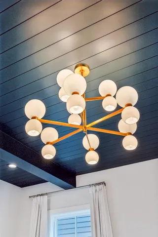 a bedroom with furniture and a chandelier