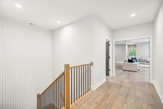 a view of a patio with couches table and chairs with wooden floor