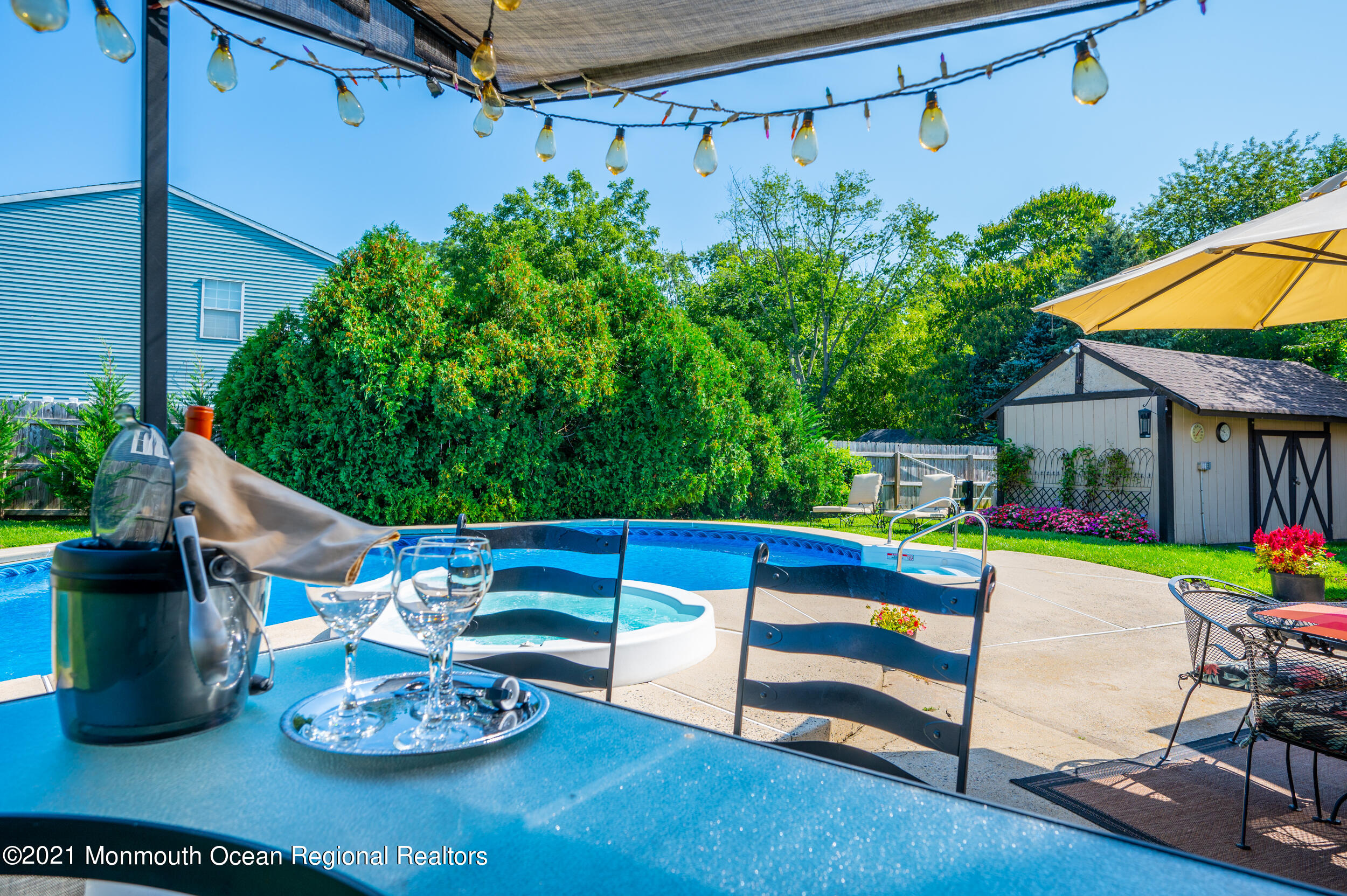 7 New Friendship Road Howell, NJ 07731 - Photo 13 of 26 a view of a patio with table and chairs potted plants with wooden floor