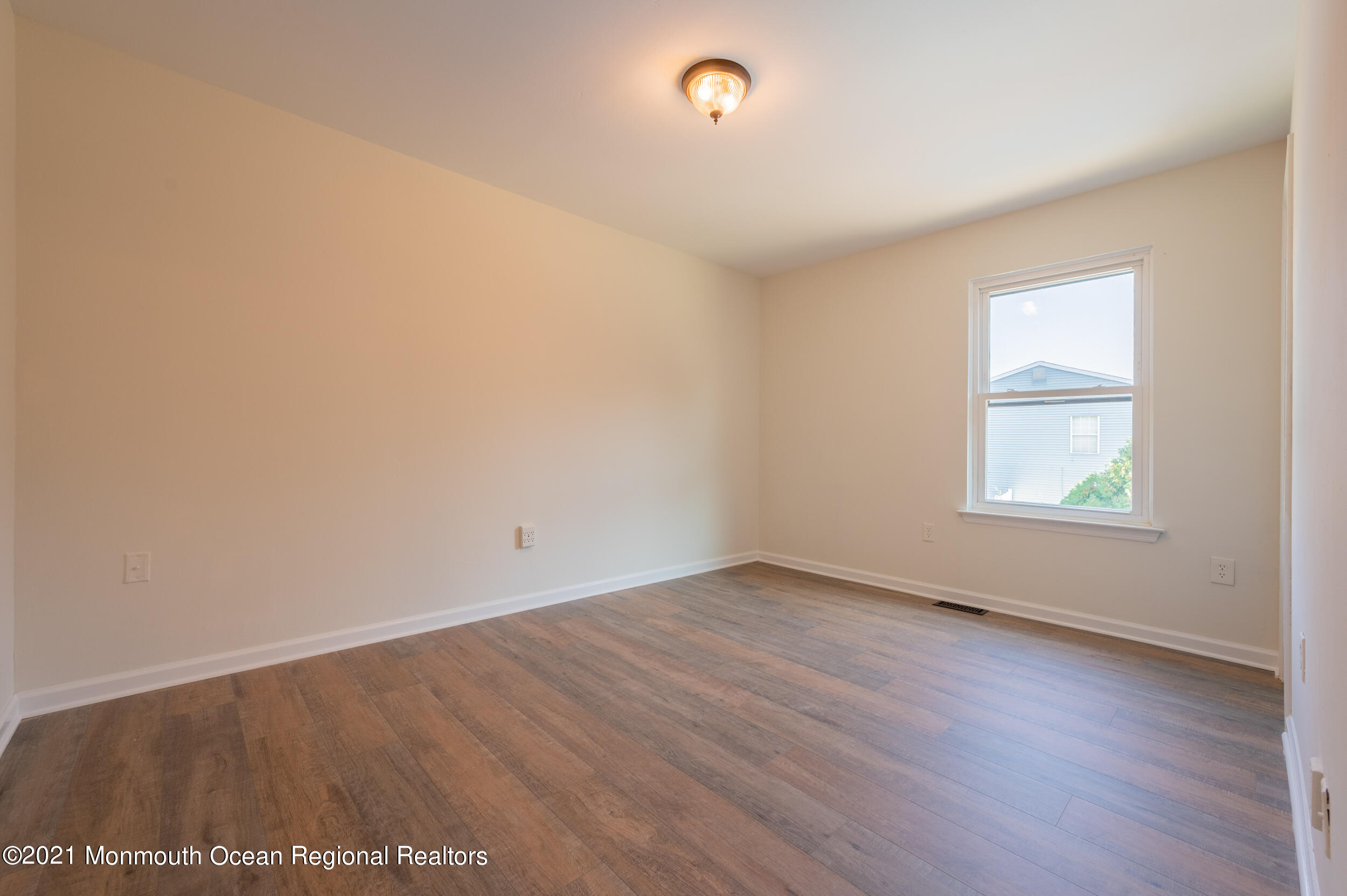 7 New Friendship Road Howell, NJ 07731 - Photo 22 of 26 an empty room with wooden floor and windows