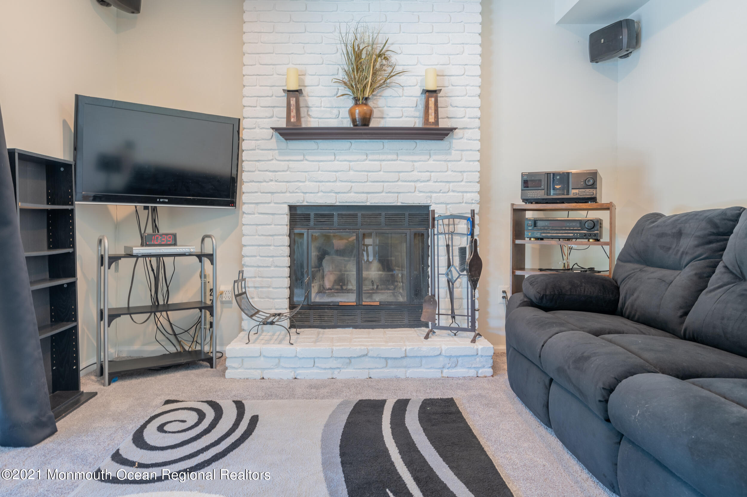 7 New Friendship Road Howell, NJ 07731 - Photo 10 of 26 a living room with furniture a flat screen tv and a fireplace