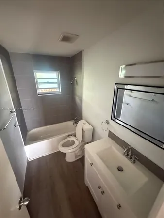 a bathroom with a tub sink and toilet