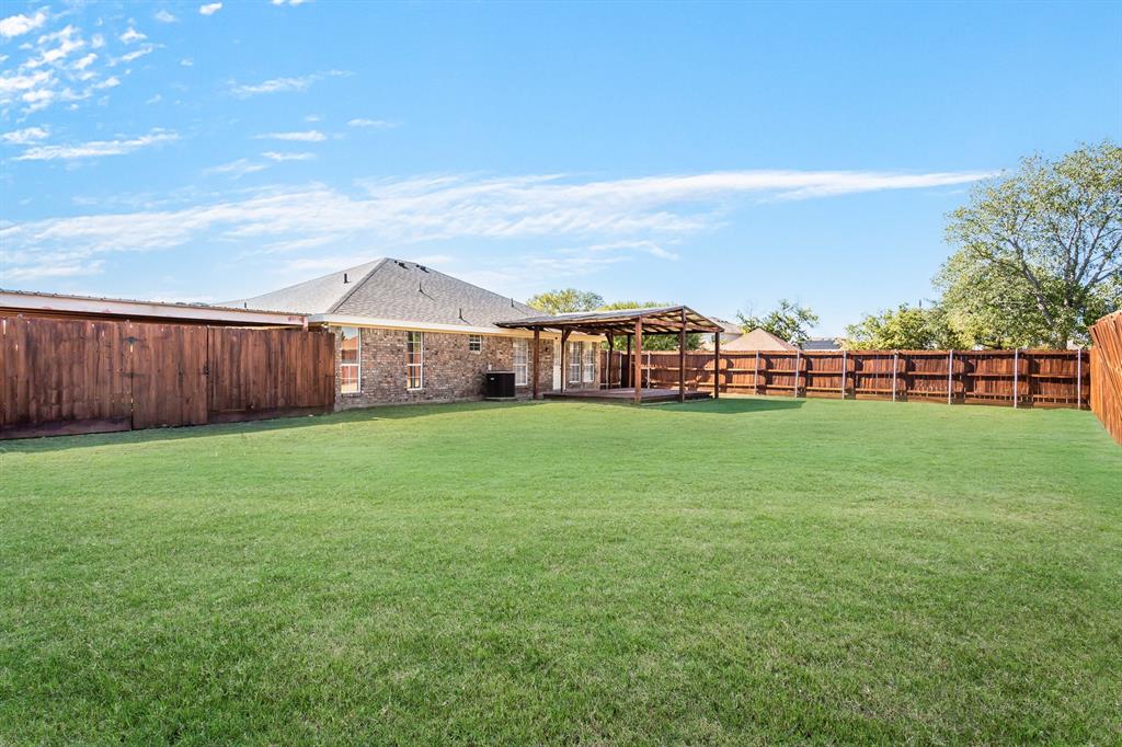 712 Billups Street Van Alstyne, TX 75495 - Photo 38 of 38 a view of a yard with a house in the background
