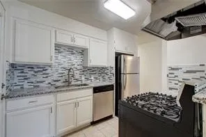 a kitchen with stainless steel appliances granite countertop a stove and a refrigerator