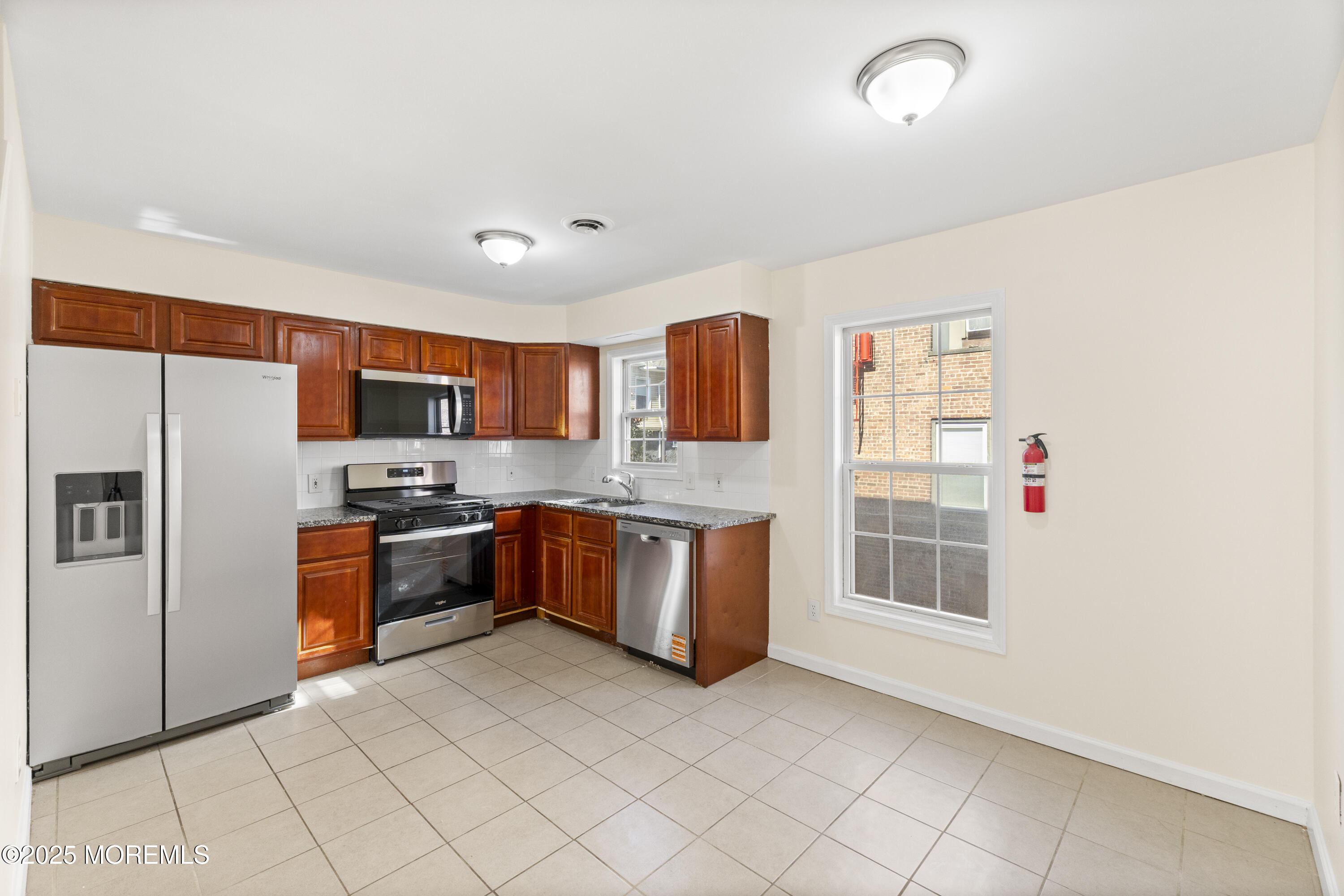 12 Carmella Court Newark, NJ 07104 - Photo 14 of 41 a kitchen with stainless steel appliances a refrigerator and a sink