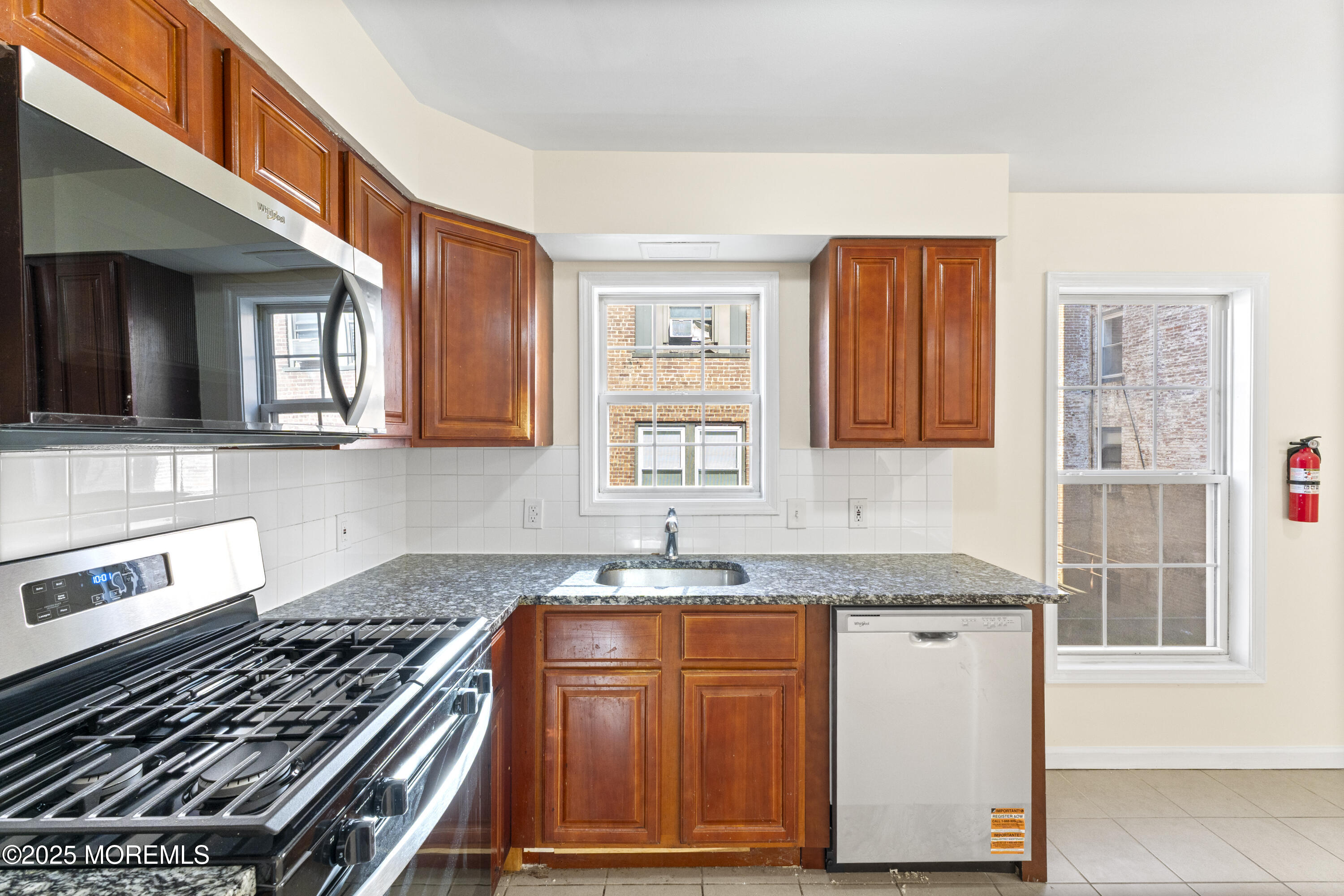12 Carmella Court Newark, NJ 07104 - Photo 17 of 41 a kitchen with granite countertop a stove and a sink