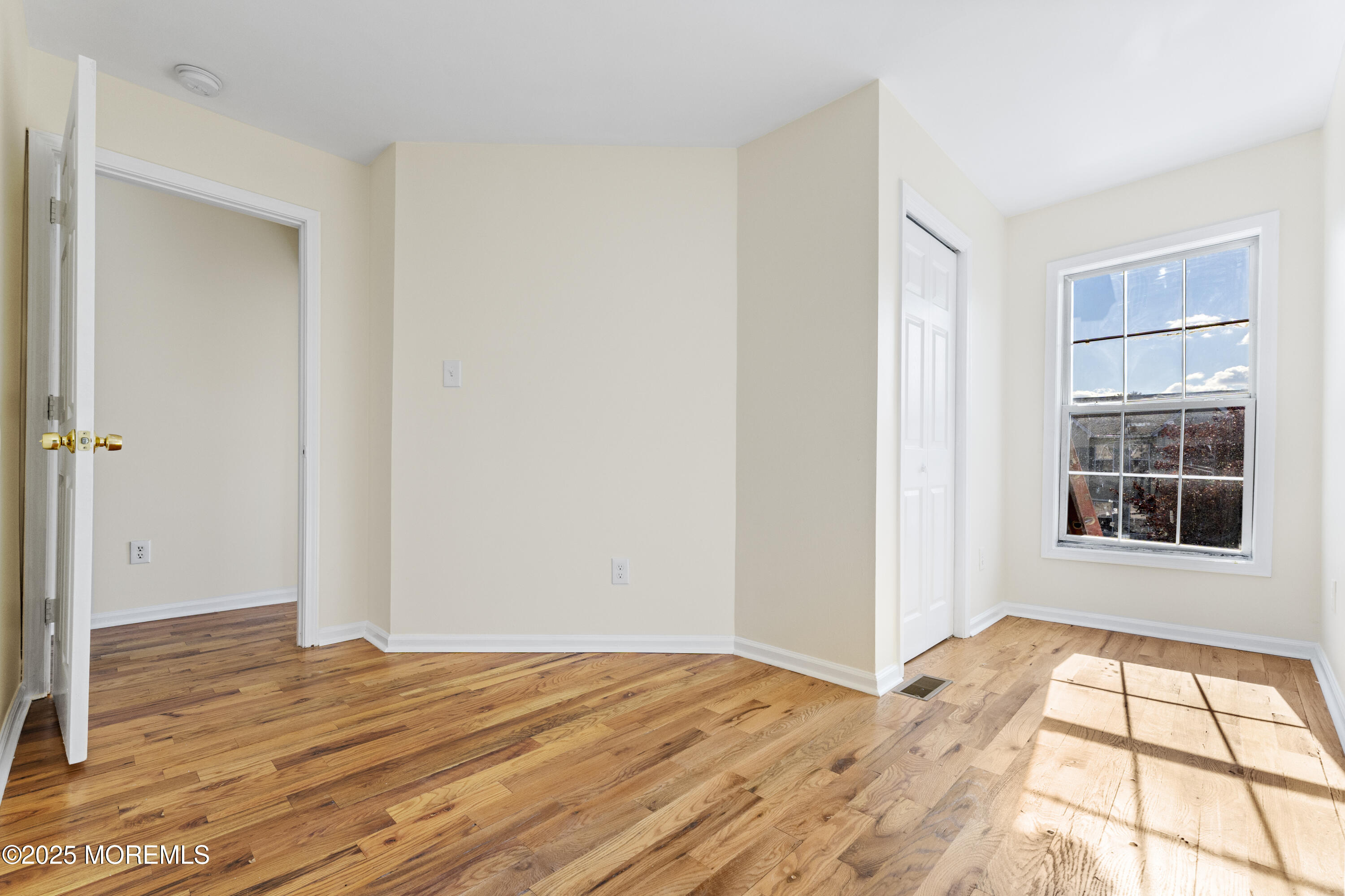 12 Carmella Court Newark, NJ 07104 - Photo 22 of 41 a view of an empty room with wooden floor and a window