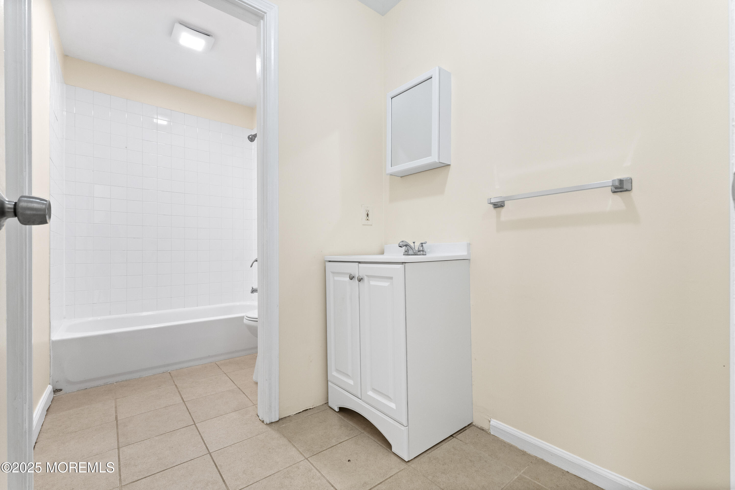 12 Carmella Court Newark, NJ 07104 - Photo 24 of 41 a bathroom with a bathtub sink and mirror