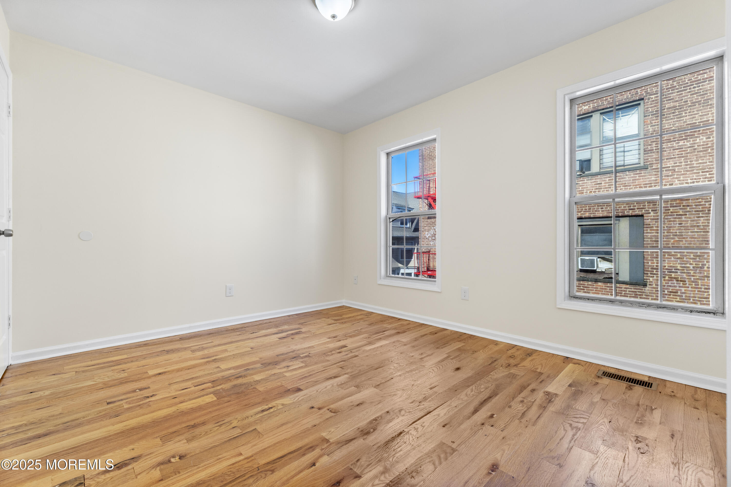 12 Carmella Court Newark, NJ 07104 - Photo 29 of 41 a view of an empty room with wooden floor and a window