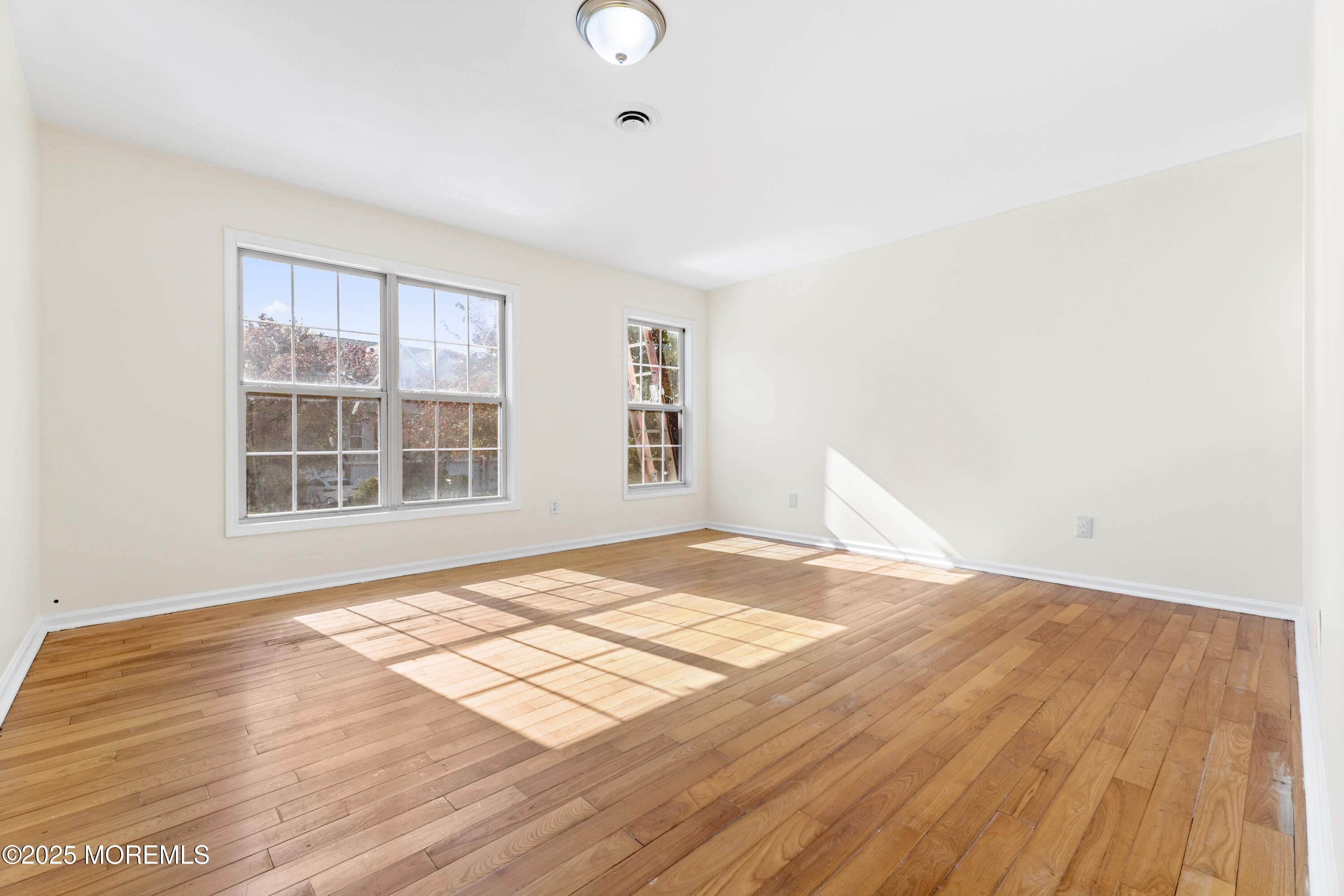 12 Carmella Court Newark, NJ 07104 - Photo 8 of 41 a view of empty room with wooden floor and fan
