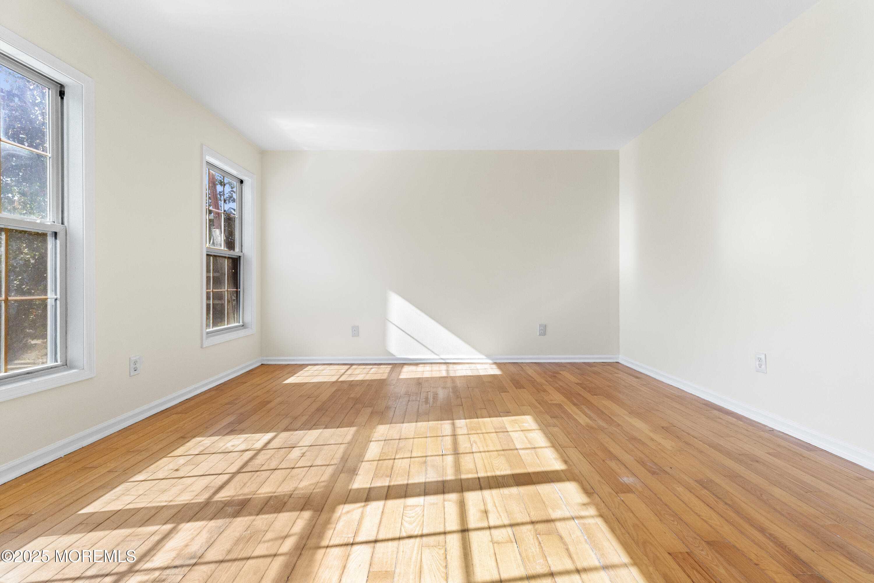 12 Carmella Court Newark, NJ 07104 - Photo 10 of 41 a view of an empty room with window and wooden floor