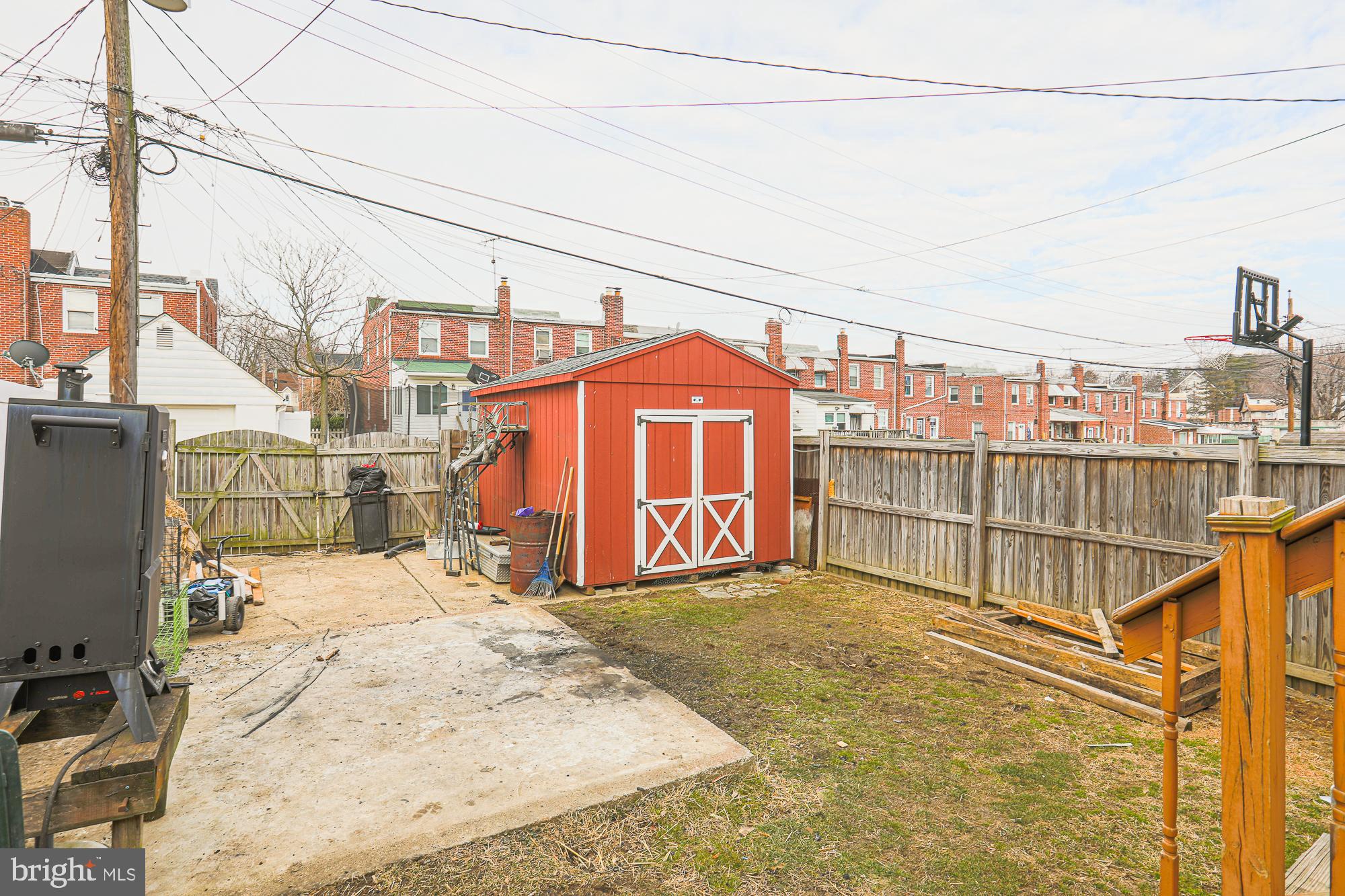 1225 Neighbors Avenue Rosedale, MD 21237 - Photo 28 of 33 a view of a terrace with a bench and iron fence