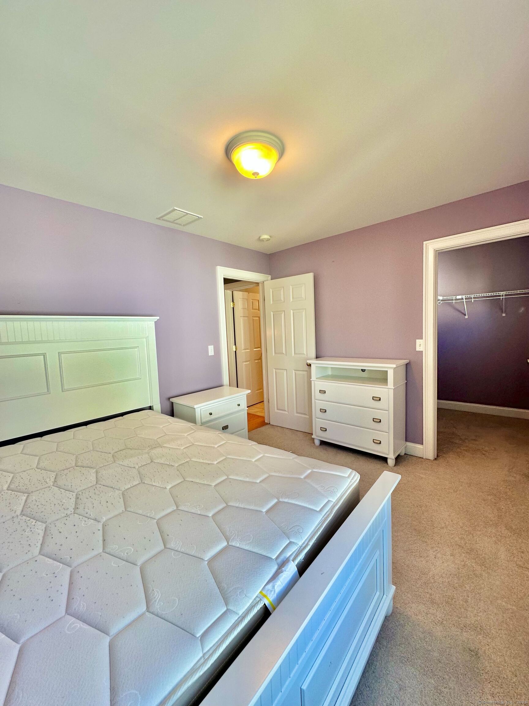 564 Black Rock Turnpike, Unit 564 Fairfield, CT 06825 - Photo 16 of 24 a spacious bedroom with a bed and a cabinets