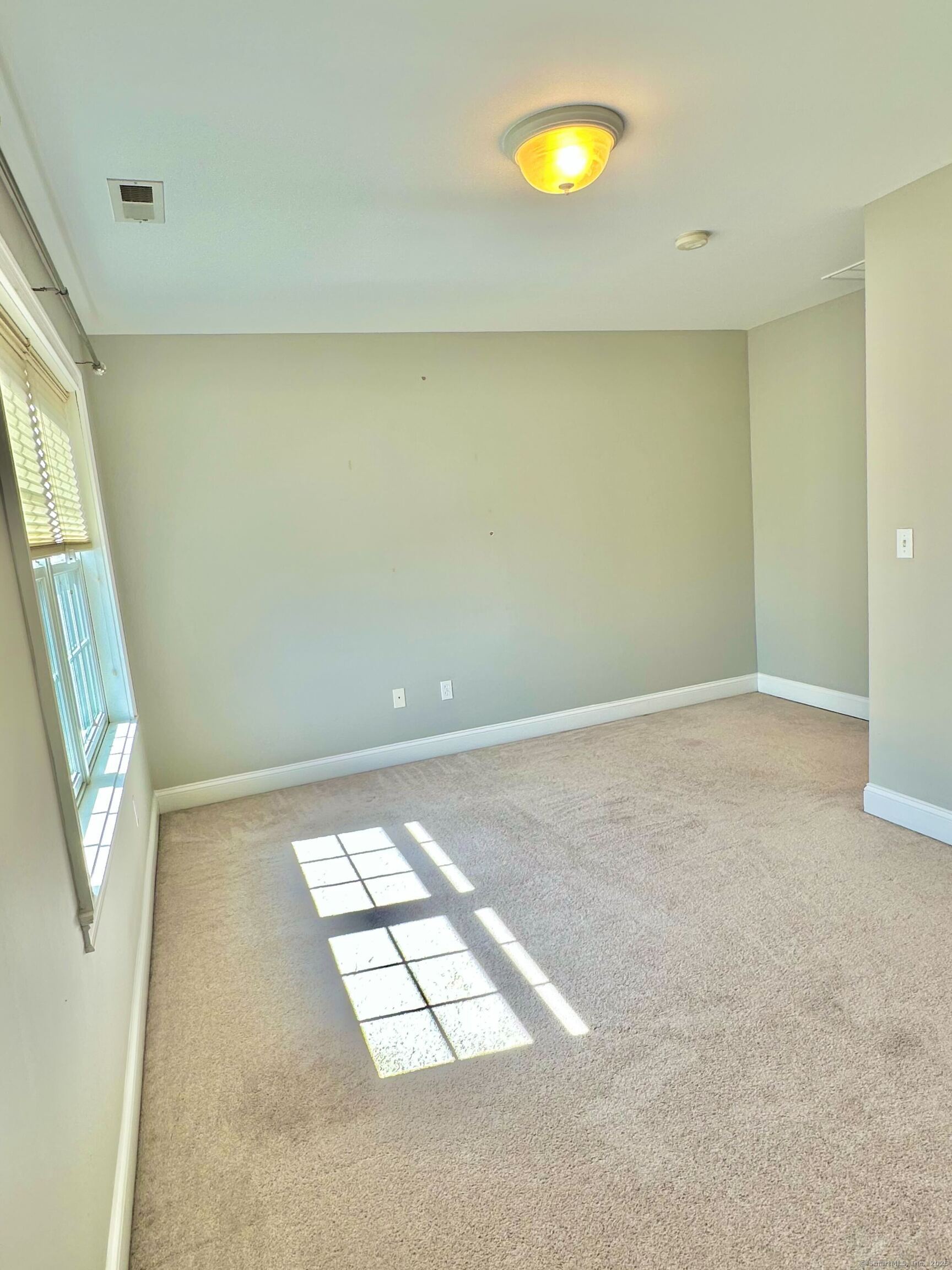 564 Black Rock Turnpike, Unit 564 Fairfield, CT 06825 - Photo 19 of 24 a view of an empty room with a window