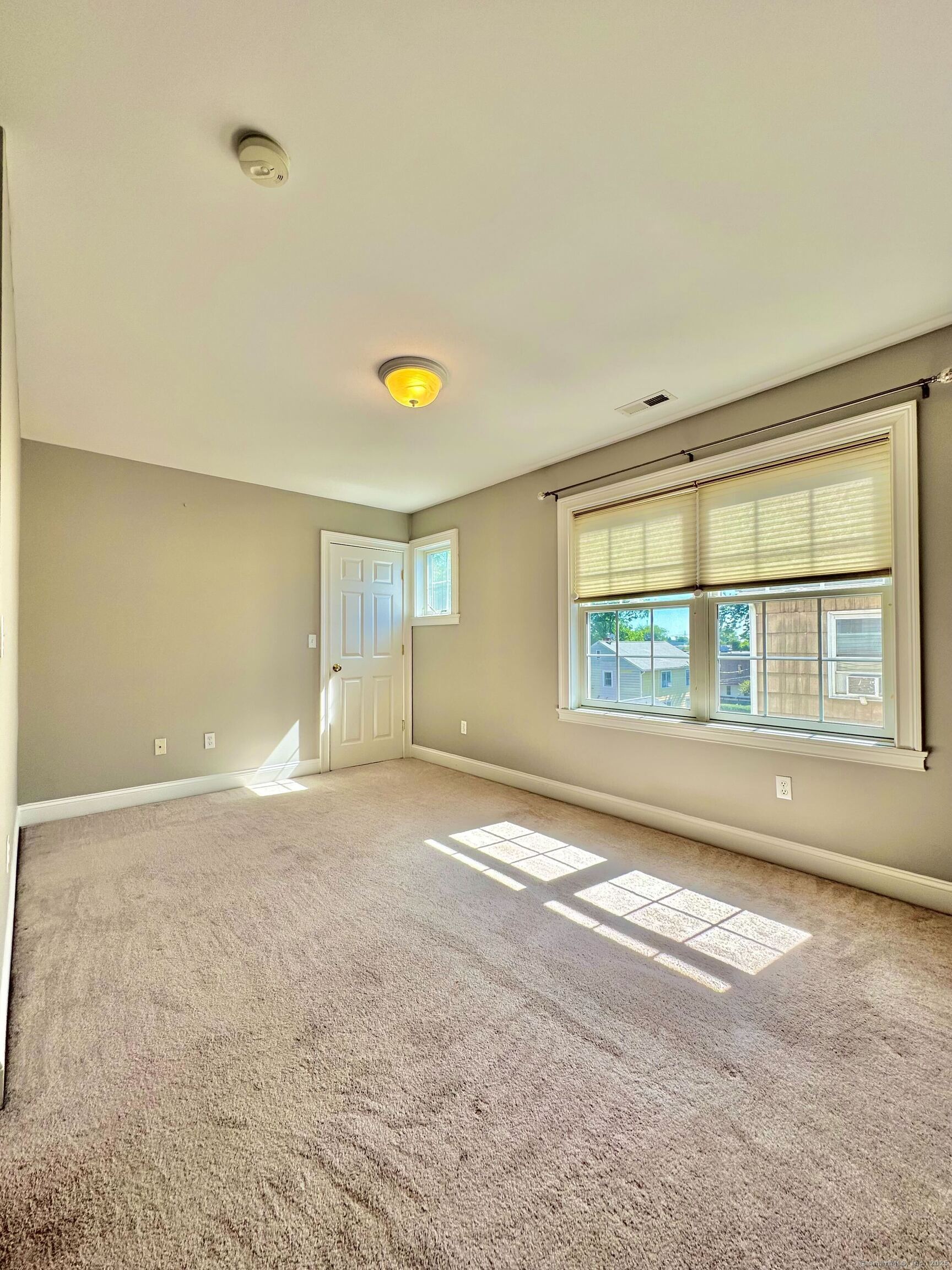 564 Black Rock Turnpike, Unit 564 Fairfield, CT 06825 - Photo 21 of 24 a view of an empty room with a window
