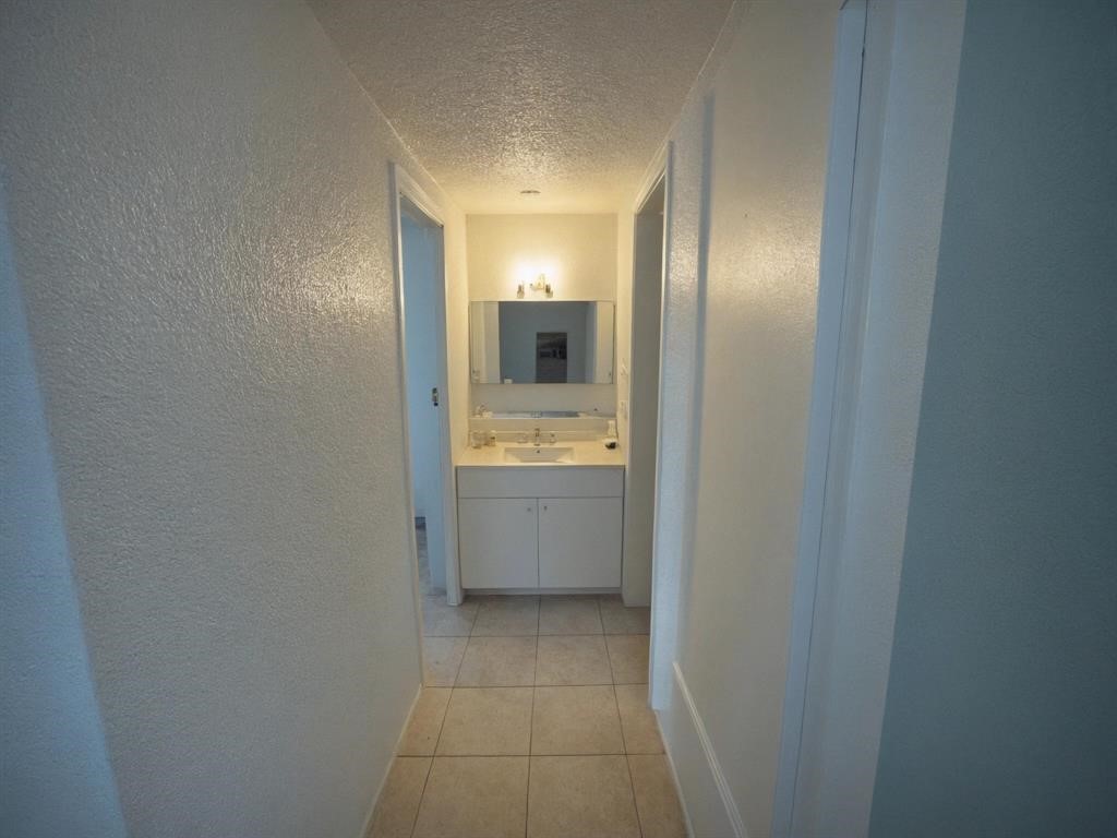 9745 Long Point Road, Unit 2 Houston, TX 77055 - Photo 4 of 7 a bathroom with a sink and a mirror