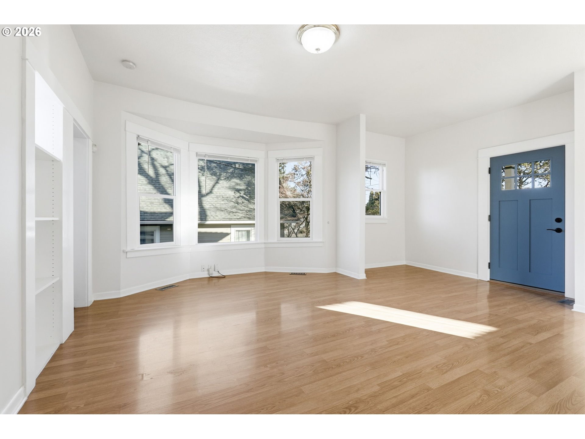 25 Southeast 76th Avenue Portland, OR 97215 - Photo 13 of 48 a view of an empty room with wooden floor and windows