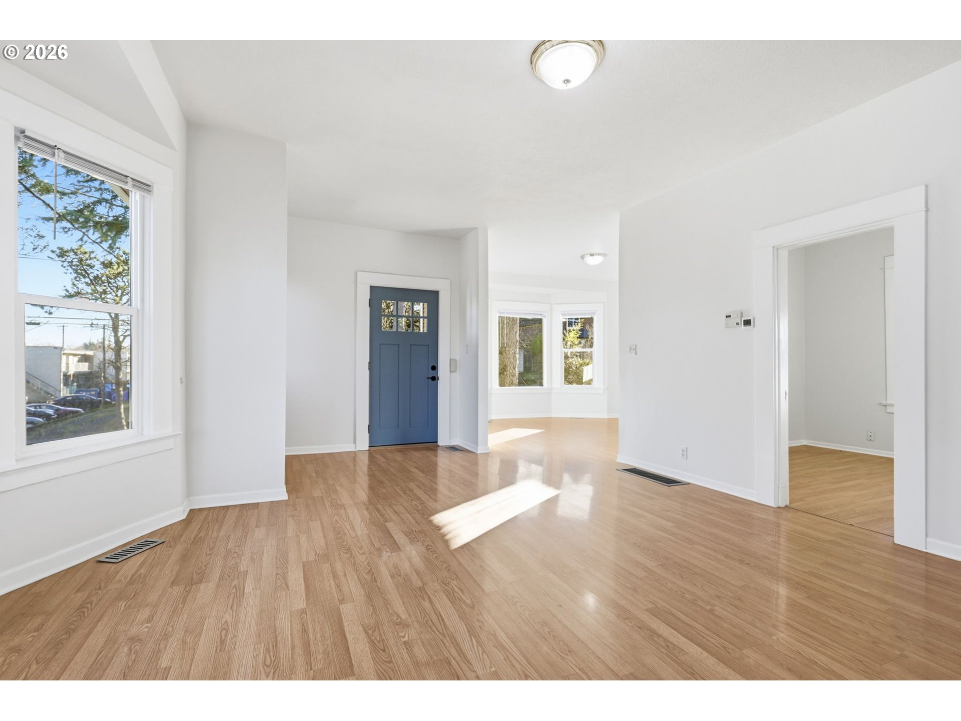 25 Southeast 76th Avenue Portland, OR 97215 - Photo 14 of 48 a view of an empty room with wooden floor and a window