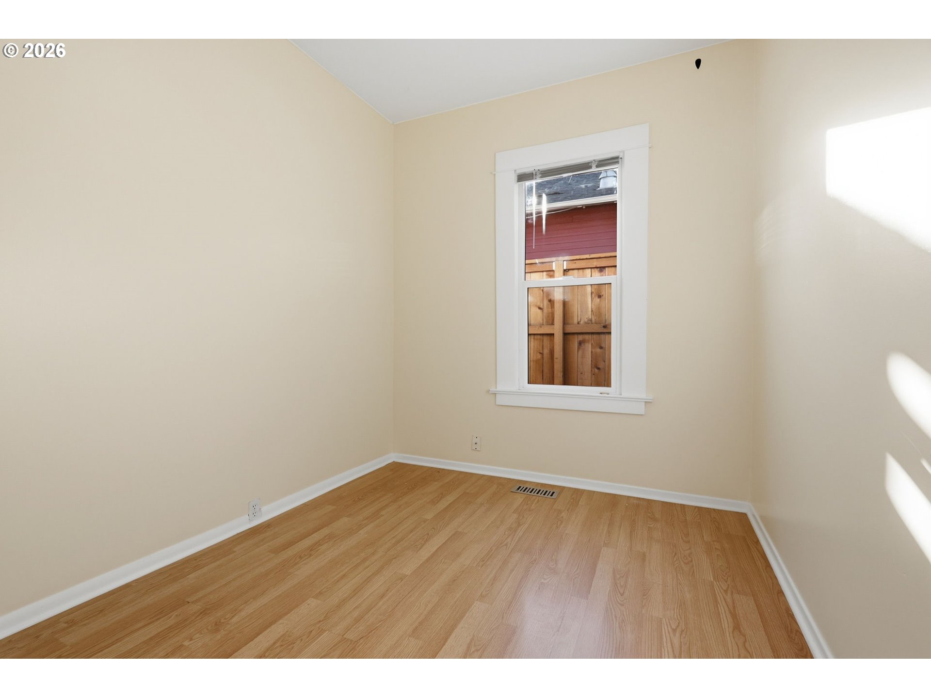 25 Southeast 76th Avenue Portland, OR 97215 - Photo 17 of 48 a view of an empty room with wooden floor and a window