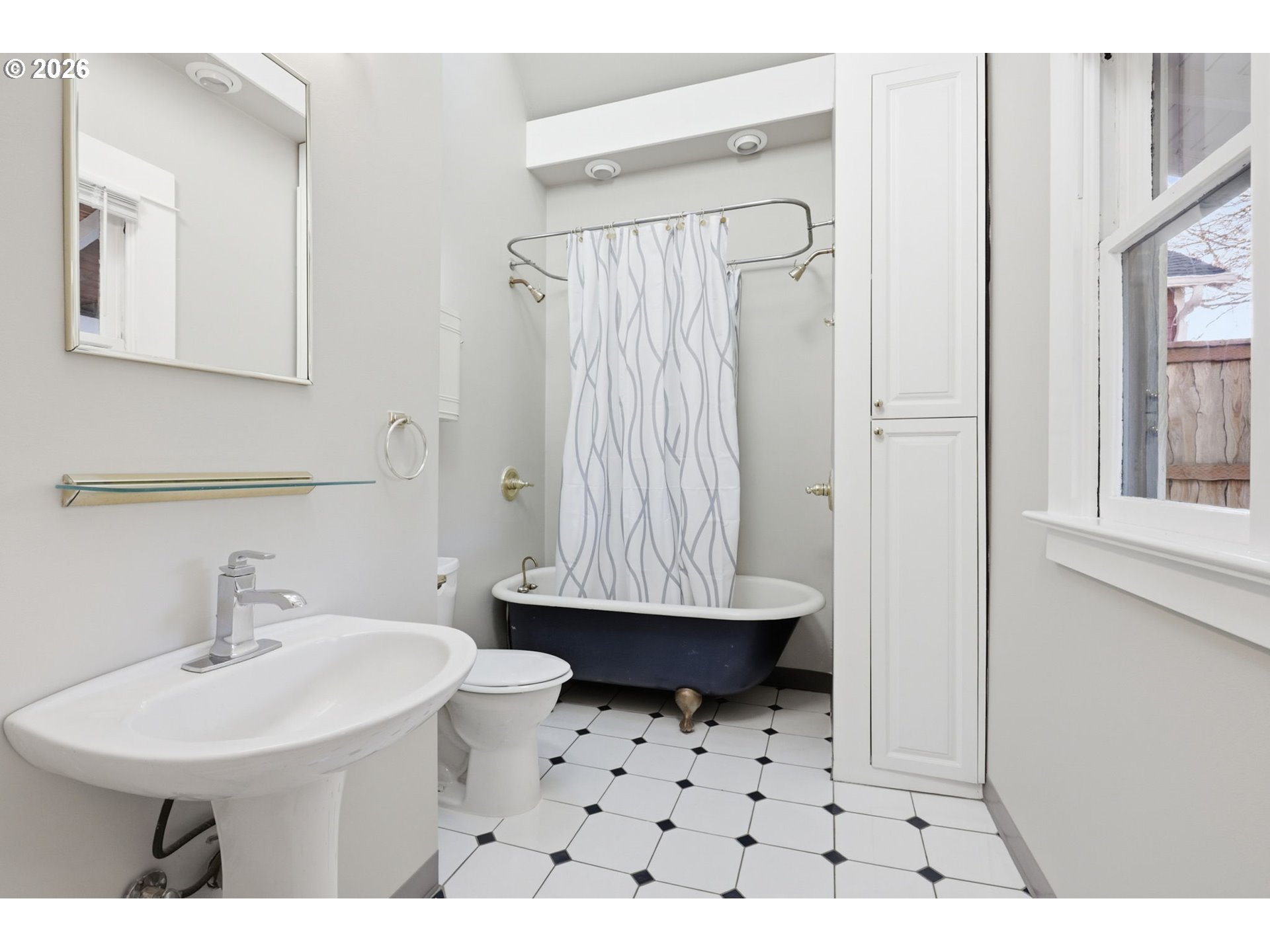 25 Southeast 76th Avenue Portland, OR 97215 - Photo 22 of 48 a bathroom with a sink a mirror and a shower