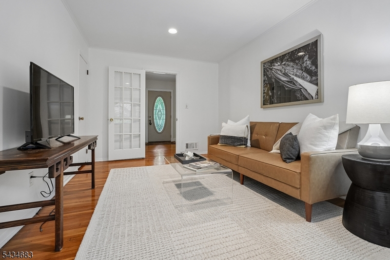 106 Division Avenue Summit, NJ 07901 - Photo 15 of 38 a living room with furniture a wooden floor and a flat screen tv