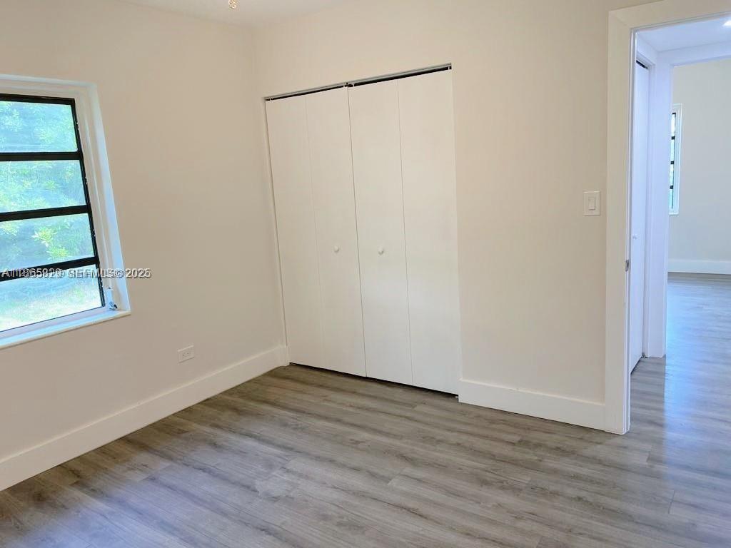 15061 Southwest 296th Street Homestead, FL 33033 - Photo 12 of 15 a view of a small space with wooden floor and a window