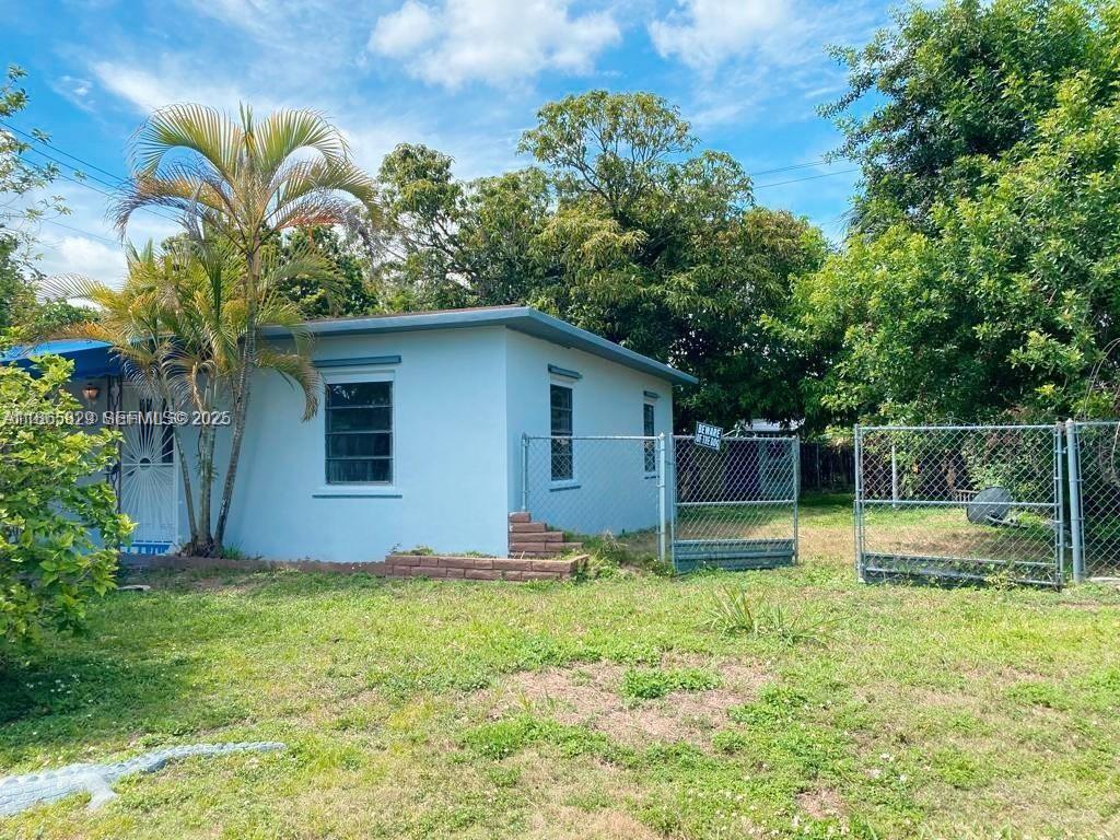 15061 Southwest 296th Street Homestead, FL 33033 - Photo 15 of 15 a backyard of a house with table and chairs