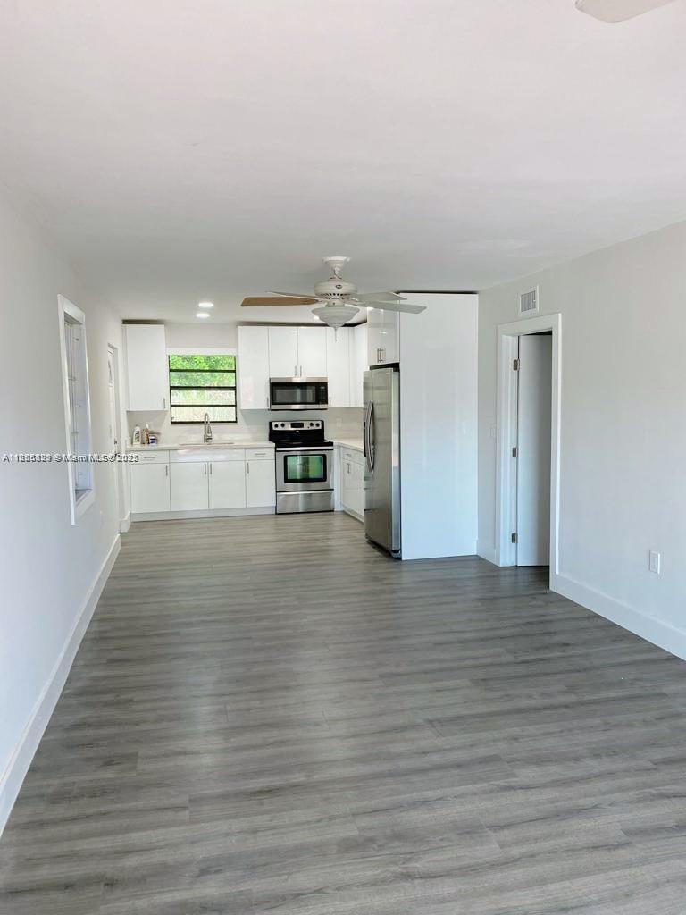 15061 Southwest 296th Street Homestead, FL 33033 - Photo 2 of 15 a view of kitchen with furniture and wooden floor