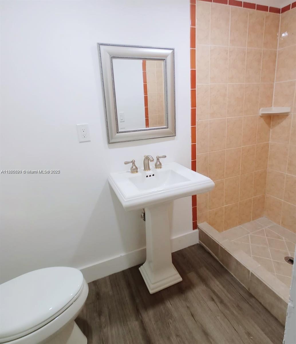 15061 Southwest 296th Street Homestead, FL 33033 - Photo 6 of 15 a bathroom with a sink toilet and mirror