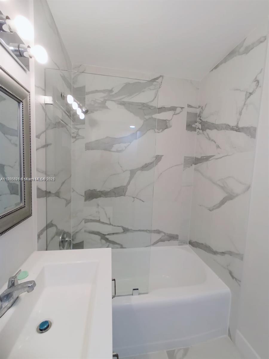 15061 Southwest 296th Street Homestead, FL 33033 - Photo 8 of 15 a bathroom with a bathtub and shower