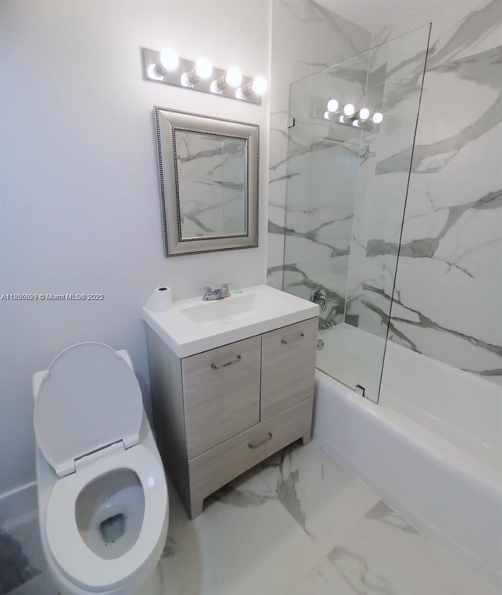 15061 Southwest 296th Street Homestead, FL 33033 - Photo 9 of 15 a bathroom with a toilet sink and mirror