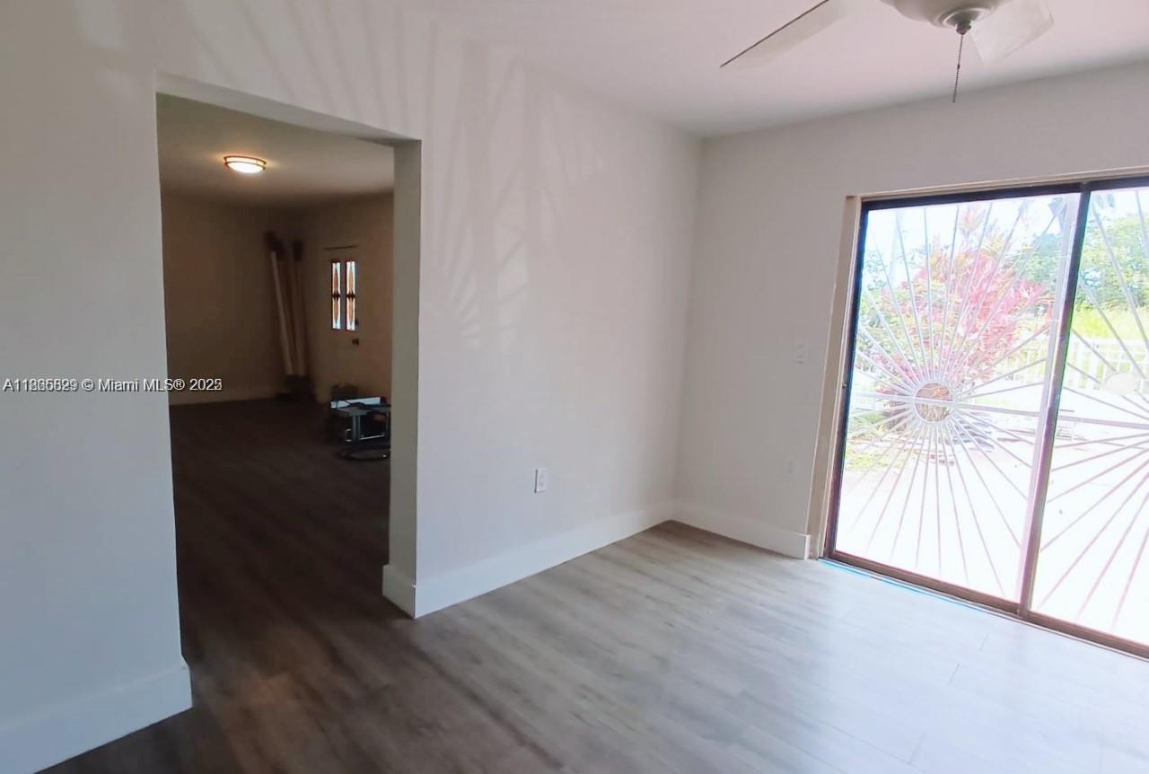 15061 Southwest 296th Street Homestead, FL 33033 - Photo 10 of 15 an empty room with wooden floor and windows