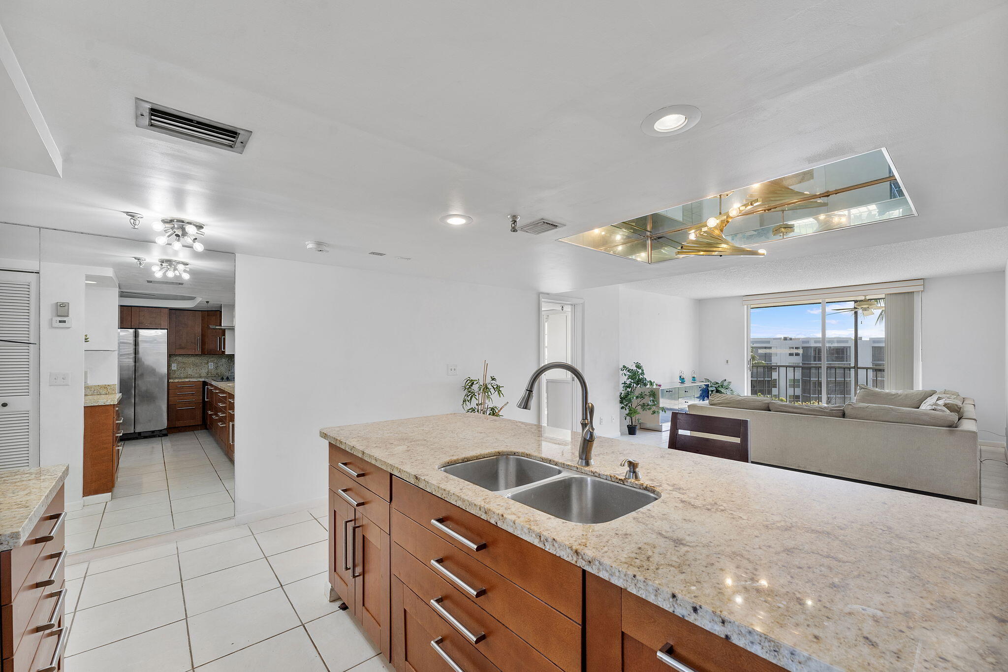 6500 Northwest 2nd Avenue, Unit 511 Boca Raton, FL 33487 - Photo 11 of 28 a kitchen with granite countertop a sink and cabinets