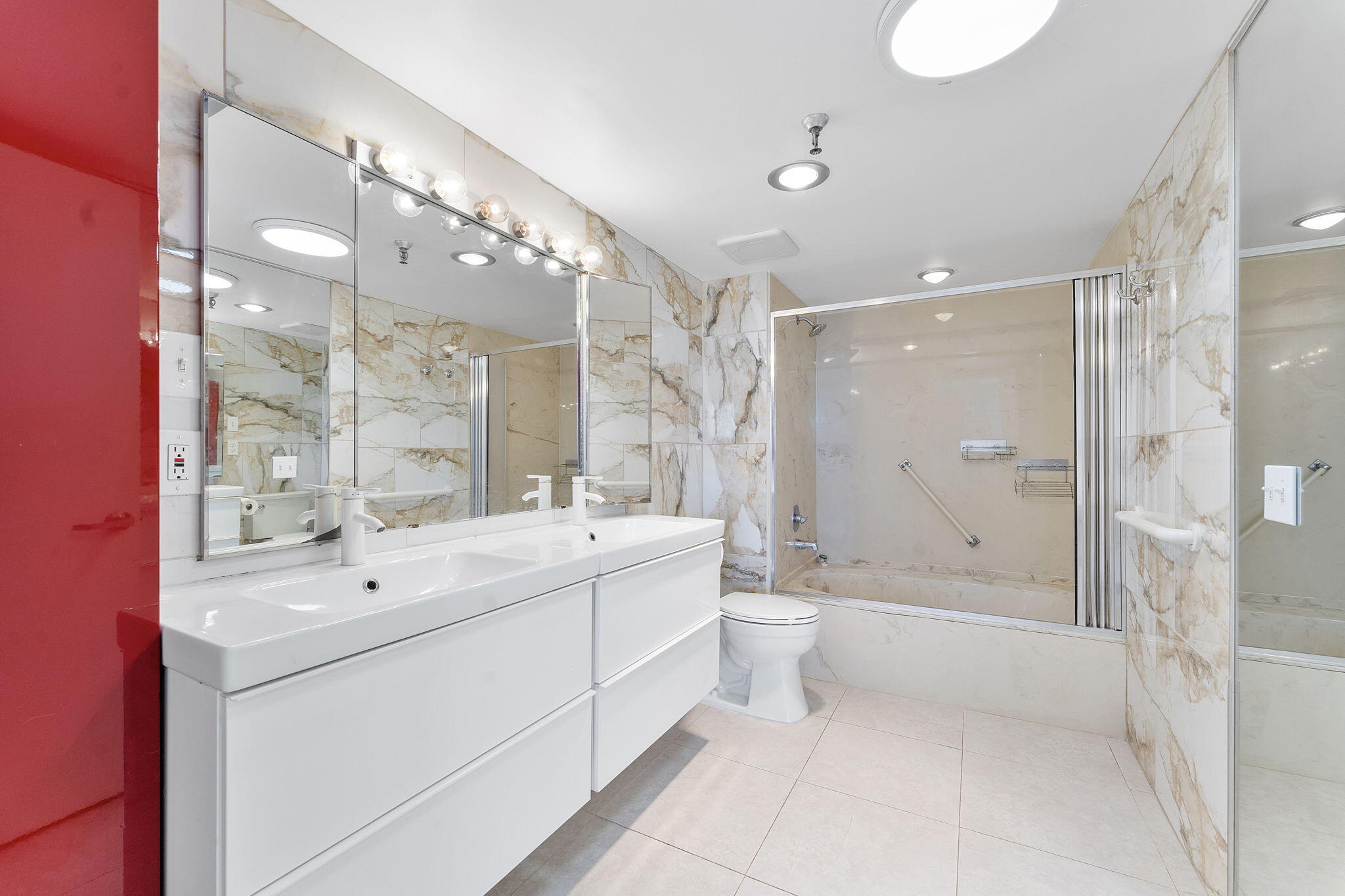 6500 Northwest 2nd Avenue, Unit 511 Boca Raton, FL 33487 - Photo 18 of 28 a bathroom with a double vanity sink mirror toilet shower and bathtub