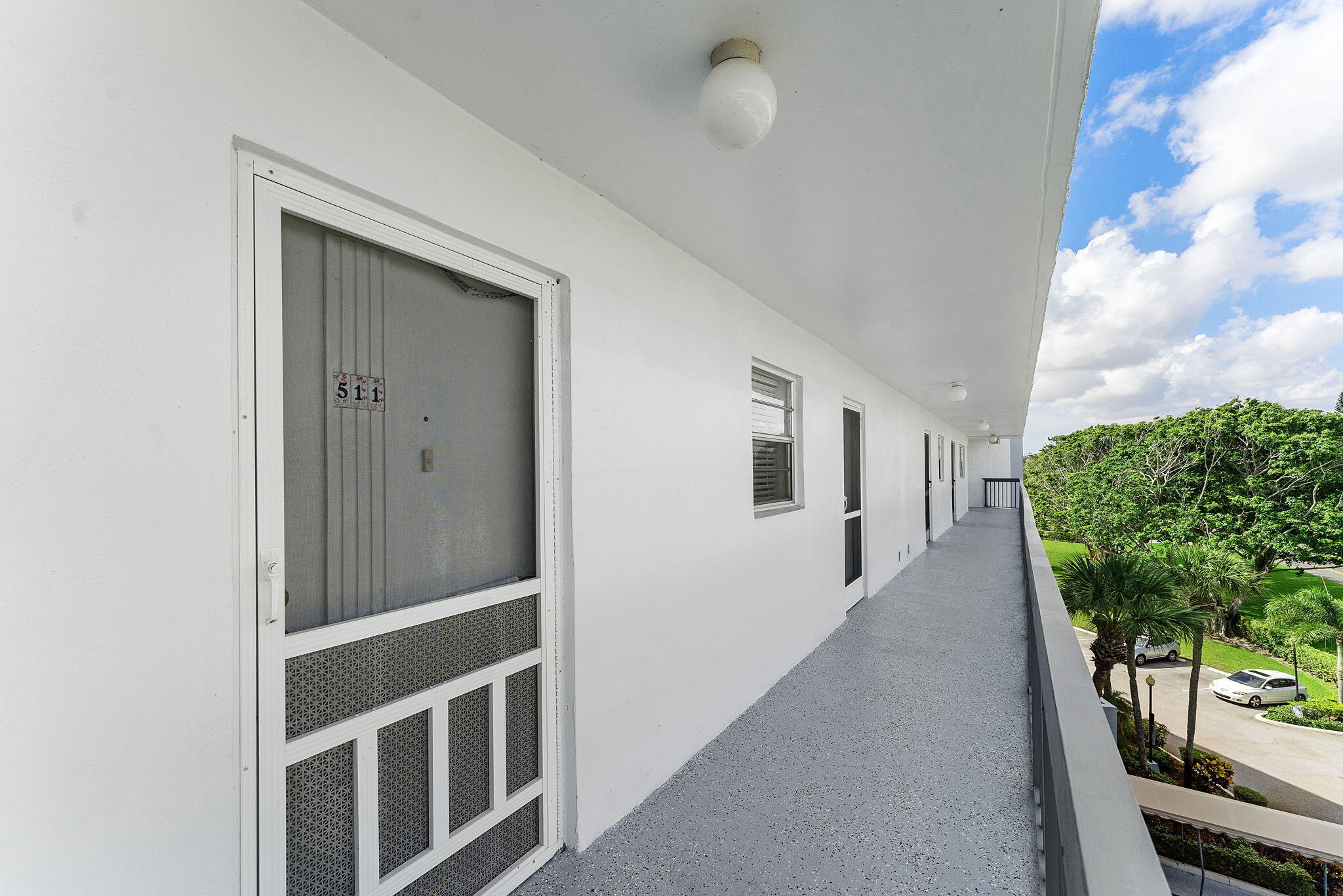 6500 Northwest 2nd Avenue, Unit 511 Boca Raton, FL 33487 - Photo 6 of 28 a hallway with wooden floor and windows
