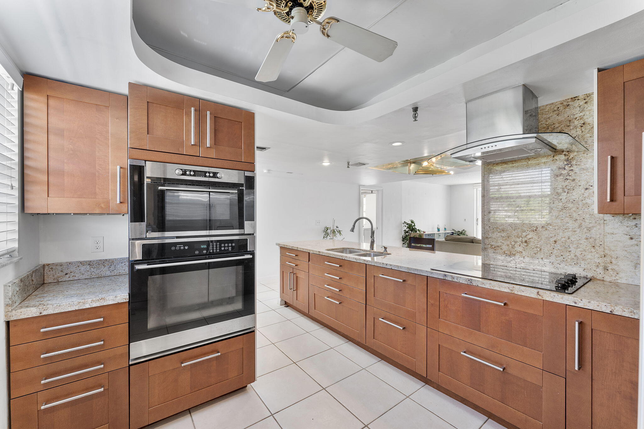 6500 Northwest 2nd Avenue, Unit 511 Boca Raton, FL 33487 - Photo 7 of 28 a kitchen with granite countertop stainless steel appliances and wooden cabinets