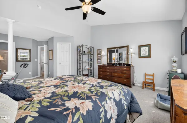 a bedroom with a bed and dresser with mirror