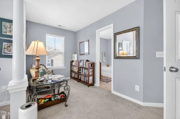 a bedroom with furniture and a lamp