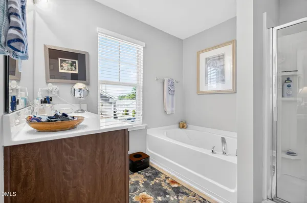 a white bath tub sitting next to a window