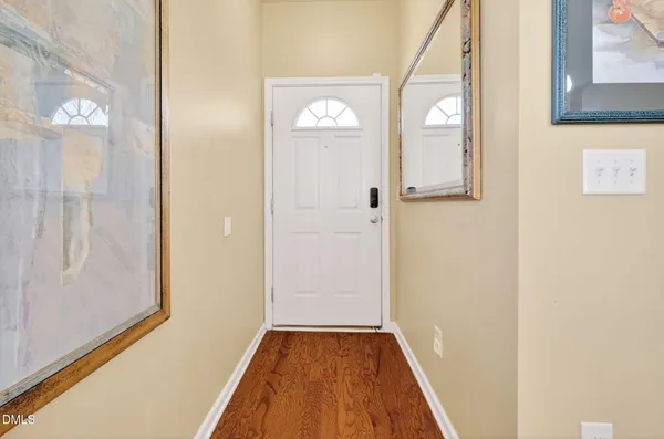 a view of hallway with wooden floor