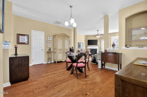 a living room with furniture a fireplace and a chandelier
