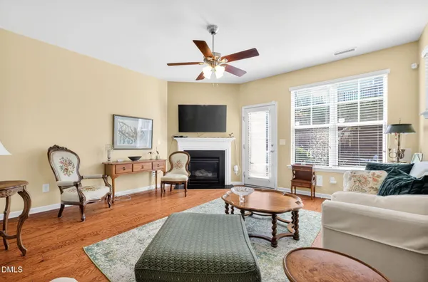 a living room with furniture fireplace and window